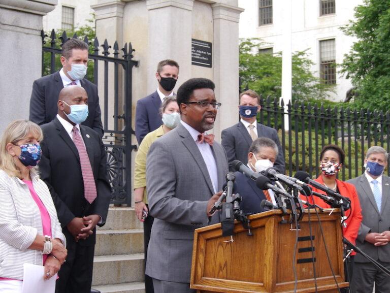 Rahsaan Hall, director, of the ACLU of Massachusetts Racial Justice Program, addresses reporters on police reform bill. Bay State Banner photo