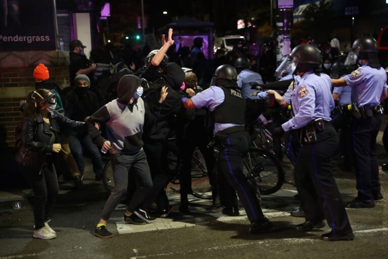 Protesters scuffle with police officers at 52nd and Market on the second day of protests after the fatal shooting of Walter Wallace Jr. Wallace was shot and killed by police officers at the 6100 block of Locust Street in West Philadelphia on Monday, Oct. 26. HEATHER KHALIFA / Philadelphia Inquirer
