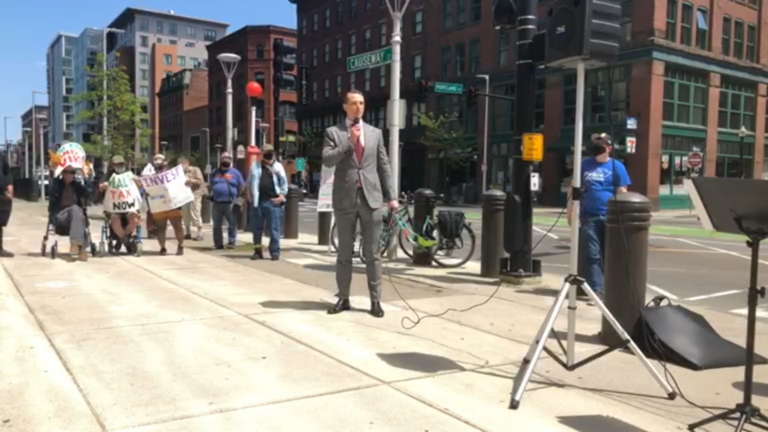 Erik Edstrom speaks about cutting the military budget at a Tax Day event on May 17th in Boston.