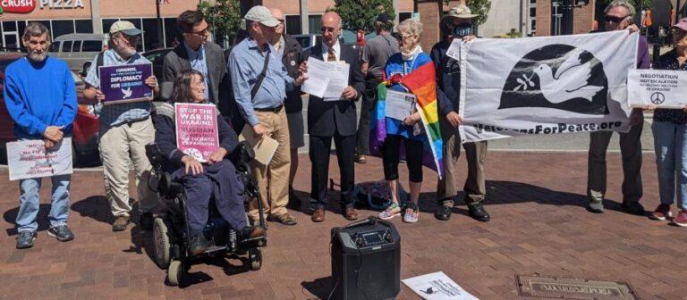 Representative Stephen Lynch’s staffer, Nick Zaferakis, accepting a letter and petition from Mass Peace Action Executive Director Cole Harrison. Other demonstrators are also pictured. Peter Blandino/Daily Collegian.