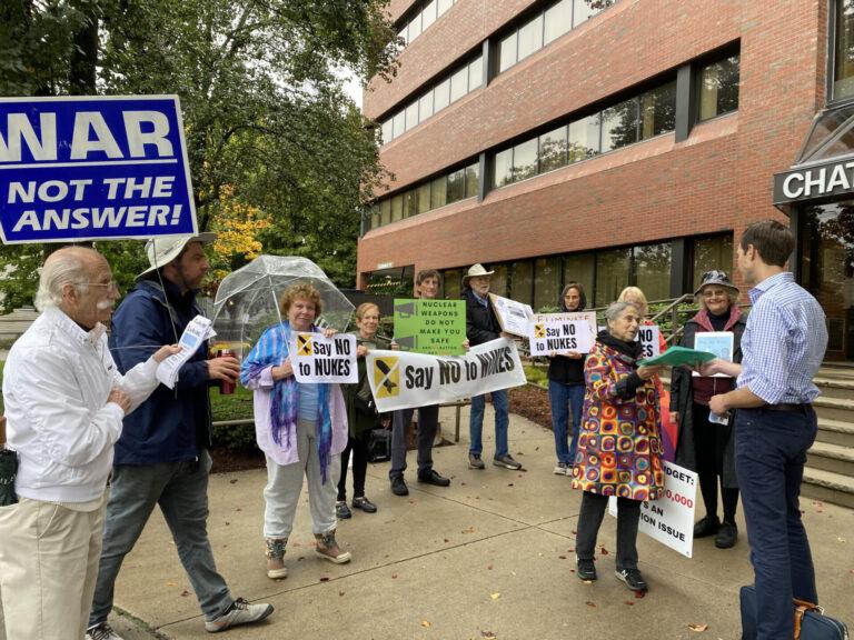Susan Mirsky hands nuclear disarmament petitions to Rep. Jake Auchincloss outside his Newton office, joined by a group of MAPA members, October 14, 2022. MAPA photo