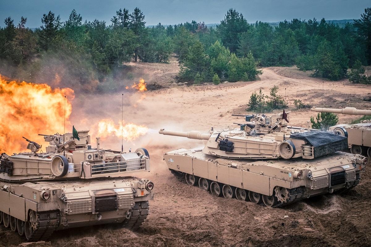 ADAZI, LATVIA, JUNE 2016 - U.S. M1 Abrams tanks fire during the "Saber Strike" NATO military exercise. Photo: Karlis Dambrans/Shutterstock