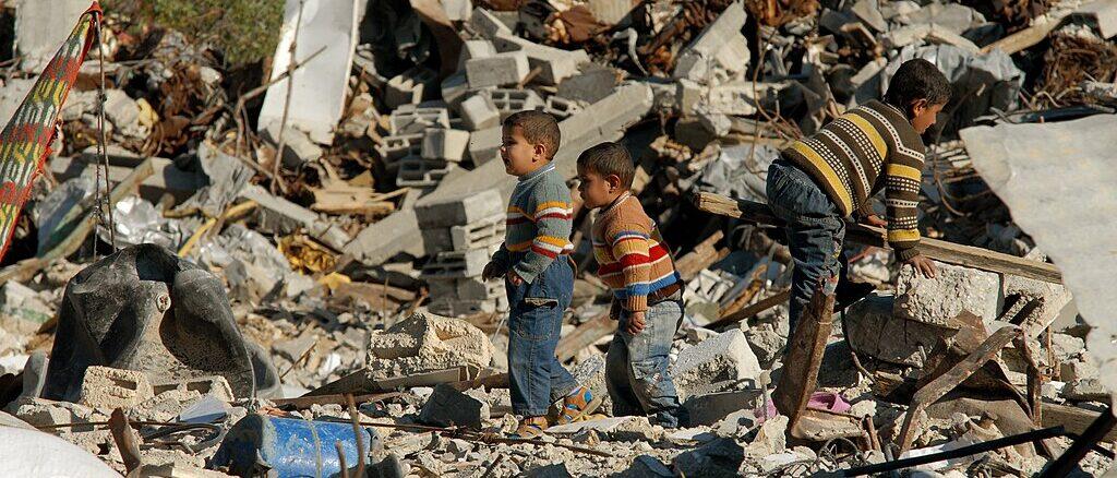 oys salvaging a destroyed building in the Gaza Strip