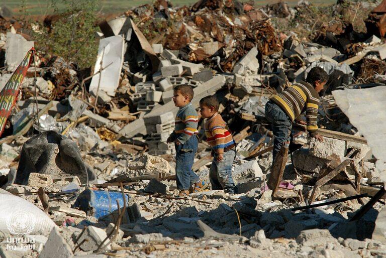 oys salvaging a destroyed building in the Gaza Strip