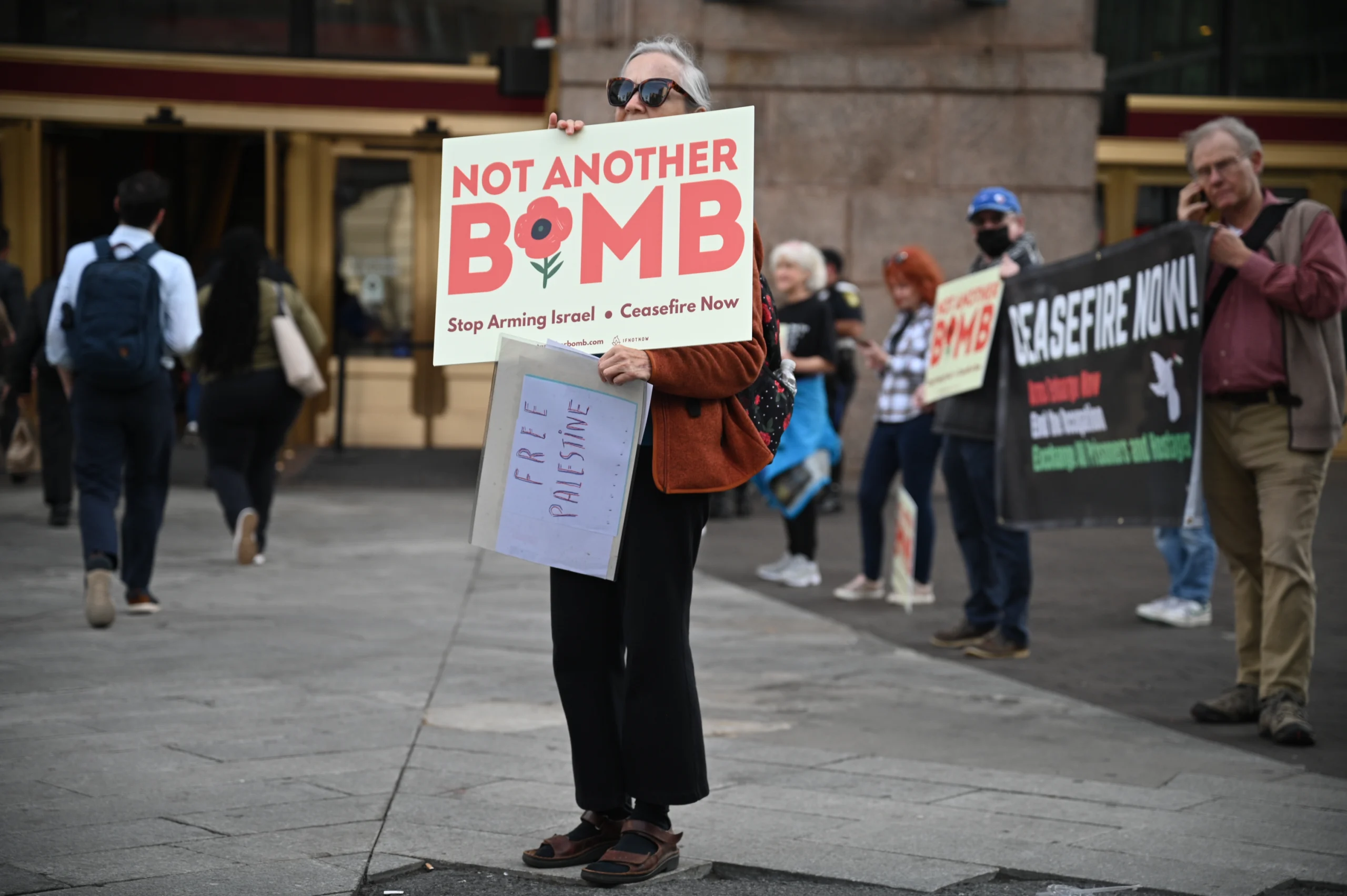 A MAPA supporter holding a Not Another Bomb ceasefire sign